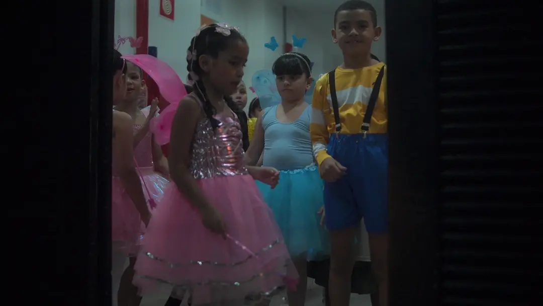 Alunos de figurino na coxia, prontos para entrar